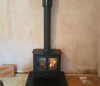 Charnwood Island 3 - with riven slate hearth installed in Hindhead, Hampshire